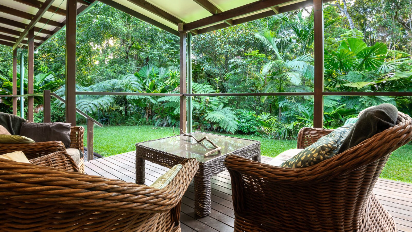 Cane chairs on the House verandah looking into rainforest