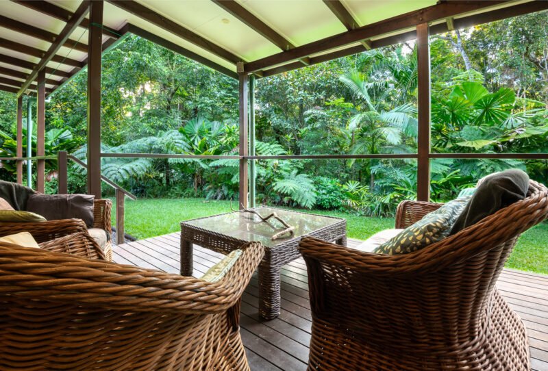 Cane chairs on the House verandah looking into rainforest